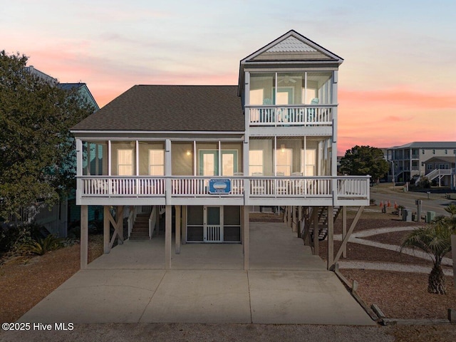 view of front facade featuring a balcony and a carport