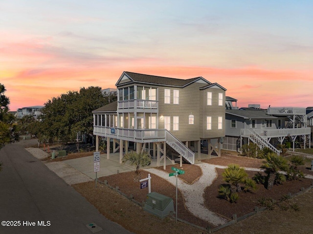 view of front of house with a balcony and a carport