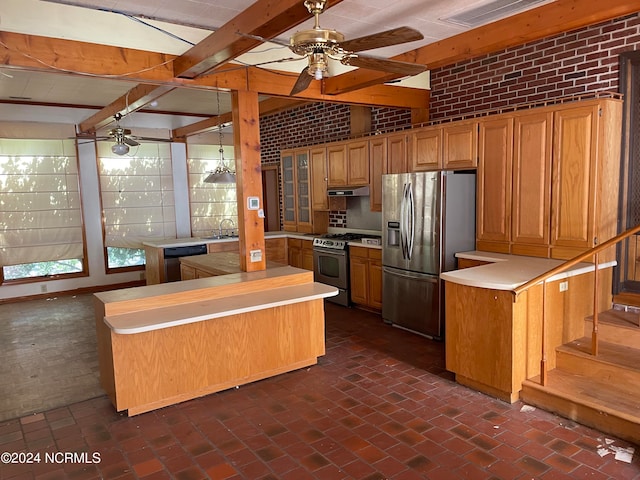 kitchen featuring appliances with stainless steel finishes, brick wall, and ceiling fan