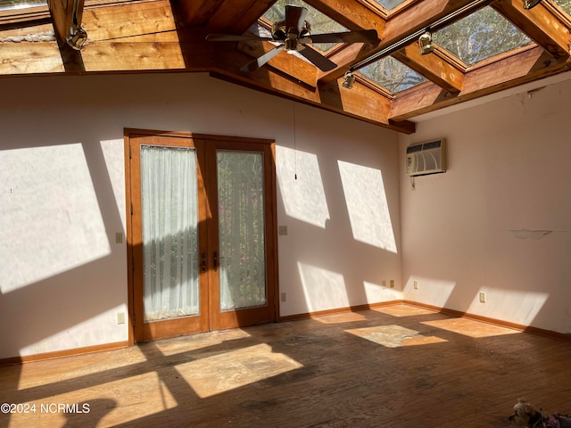 interior space featuring a skylight, ceiling fan, hardwood / wood-style flooring, and a healthy amount of sunlight