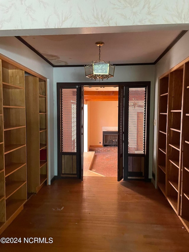 hallway with crown molding and dark hardwood / wood-style floors