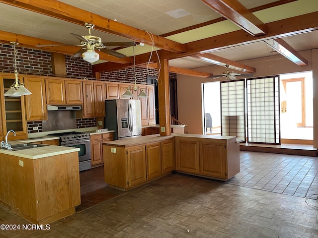 kitchen with hanging light fixtures, stainless steel appliances, sink, and ceiling fan