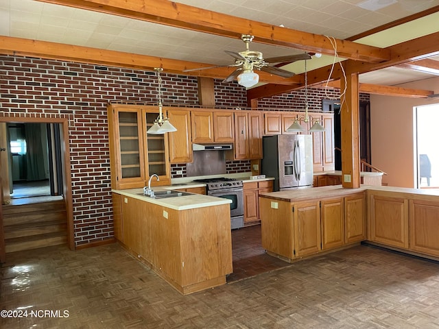 kitchen featuring kitchen peninsula, brick wall, stainless steel appliances, and ceiling fan