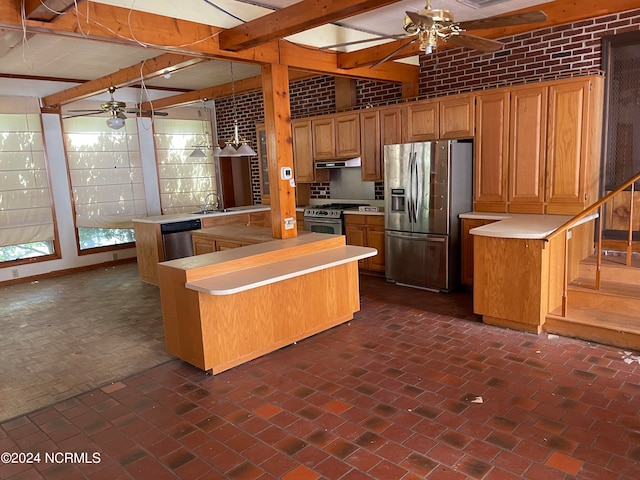 kitchen with stainless steel appliances, kitchen peninsula, a kitchen island, ceiling fan, and brick wall