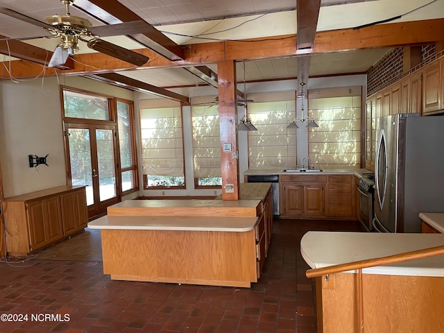 kitchen featuring french doors, stainless steel appliances, sink, ceiling fan, and a kitchen island