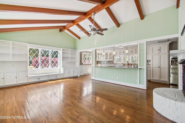 unfurnished living room featuring ceiling fan, beam ceiling, and dark hardwood / wood-style floors