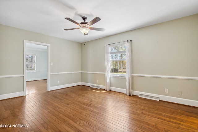 spare room with ceiling fan and dark wood-type flooring