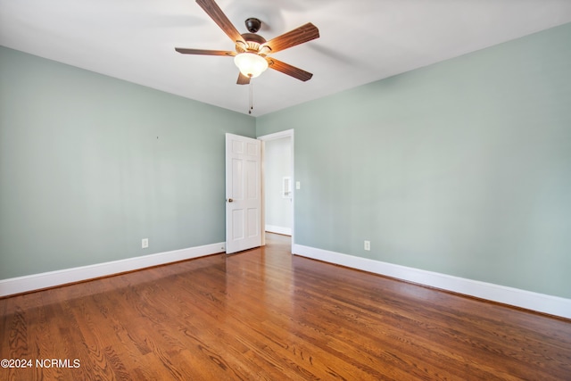 empty room featuring ceiling fan and dark hardwood / wood-style floors