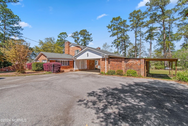 single story home featuring a carport