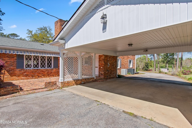 exterior space featuring central AC and a carport