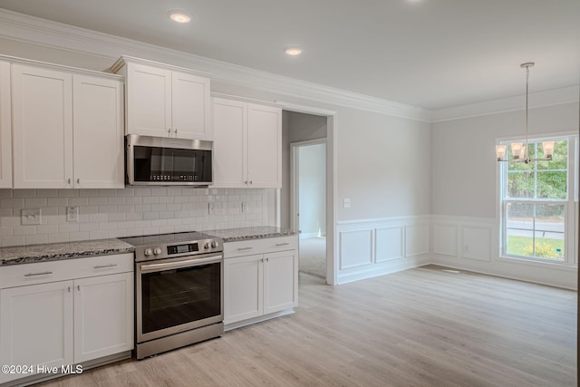 kitchen featuring white cabinets, decorative backsplash, stainless steel appliances, and light hardwood / wood-style flooring