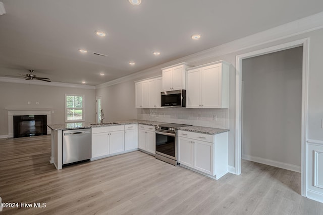 kitchen featuring sink, white cabinets, light wood-type flooring, and appliances with stainless steel finishes