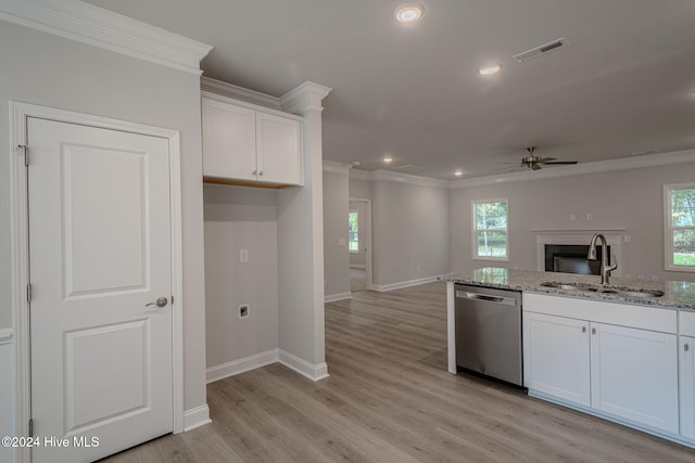 kitchen with stainless steel dishwasher, plenty of natural light, white cabinetry, and sink