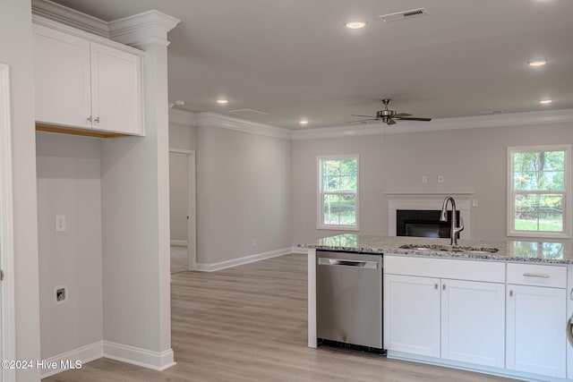 kitchen featuring sink, stainless steel dishwasher, light hardwood / wood-style floors, light stone counters, and white cabinetry