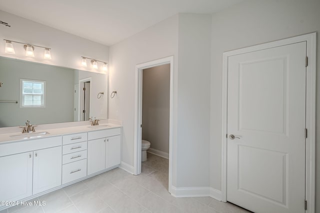 bathroom featuring tile patterned floors, vanity, and toilet