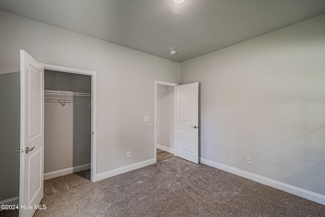 unfurnished bedroom with carpet and a closet