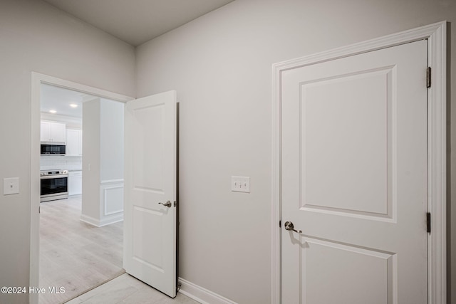 hall with light wood-type flooring