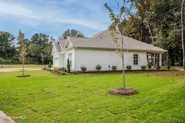 view of property exterior with a garage and a lawn