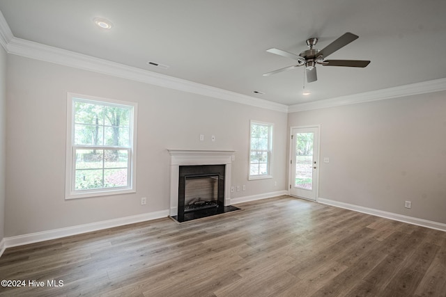 unfurnished living room featuring crown molding, hardwood / wood-style floors, and ceiling fan