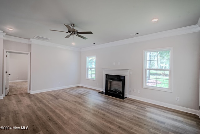 unfurnished living room with ceiling fan, hardwood / wood-style floors, and ornamental molding