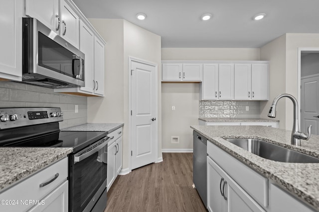 kitchen featuring sink, white cabinets, and appliances with stainless steel finishes