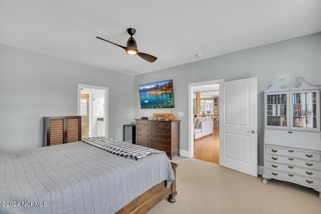 bedroom featuring ensuite bath and ceiling fan