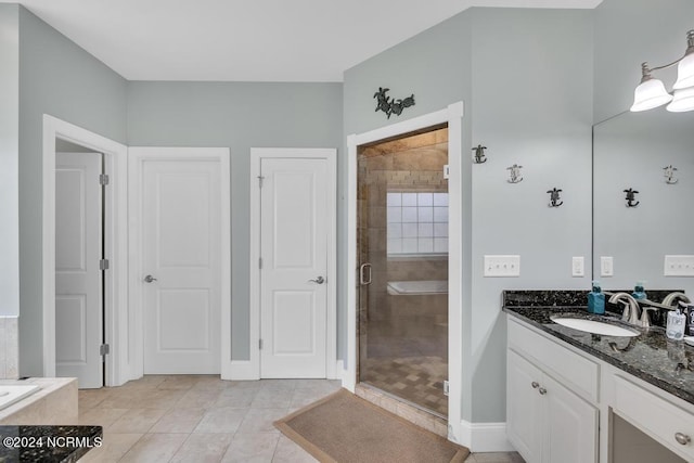 bathroom featuring tile patterned flooring, vanity, and walk in shower