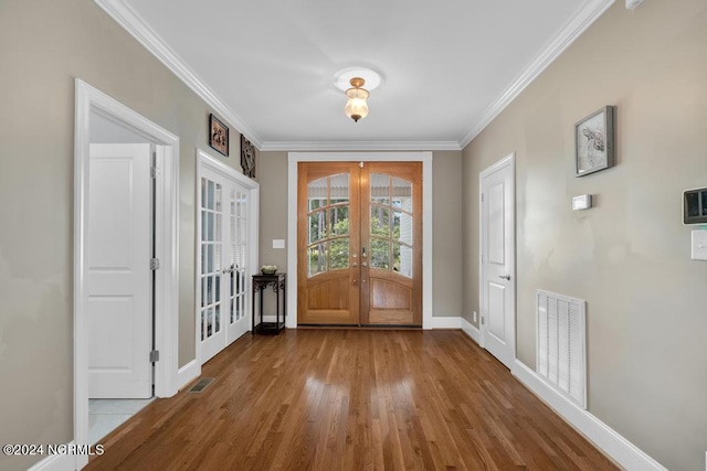 entryway featuring hardwood / wood-style flooring, crown molding, and french doors