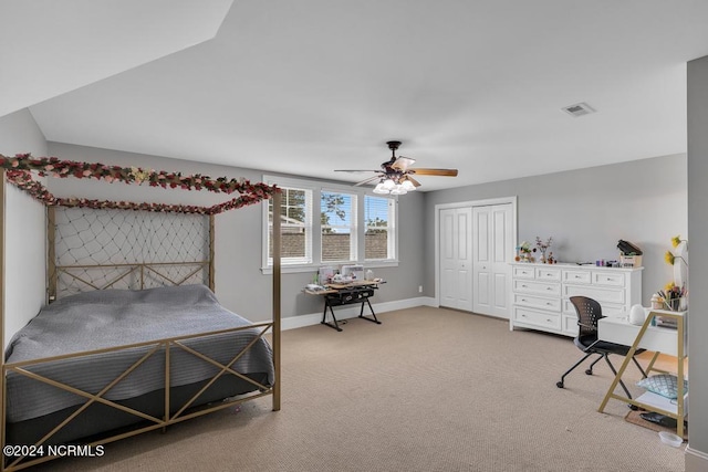 carpeted bedroom with ceiling fan and a closet