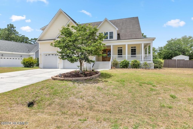 view of front facade with a garage, a porch, and a front yard