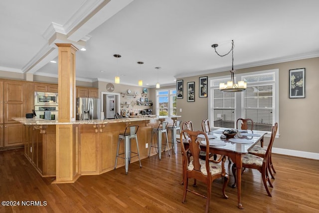 dining space with ornate columns, hardwood / wood-style floors, ornamental molding, and a notable chandelier