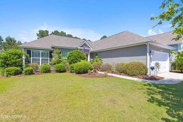 single story home with a front yard and a garage