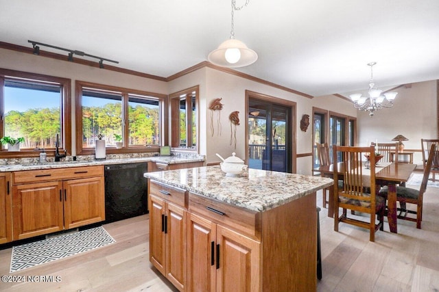 kitchen featuring an inviting chandelier, hanging light fixtures, black dishwasher, and a kitchen island