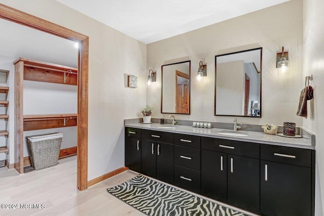 bathroom featuring double vanity and wood-type flooring