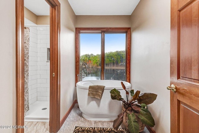 bathroom featuring tile floors and separate shower and tub