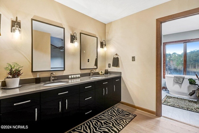 bathroom featuring double vanity and hardwood / wood-style flooring