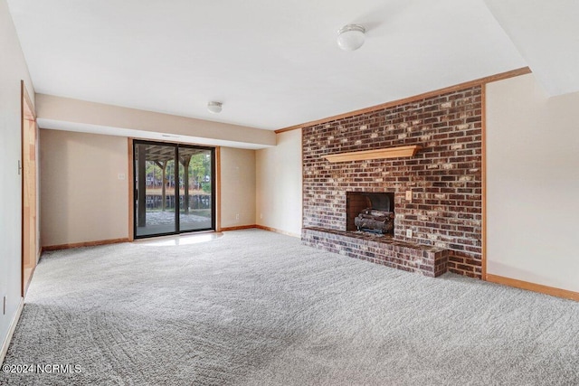 unfurnished living room featuring light carpet, ornamental molding, and a fireplace