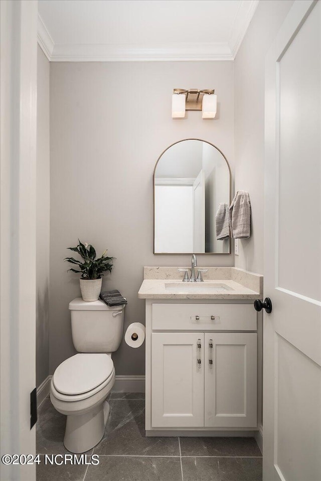 bathroom with ornamental molding, vanity, tile patterned flooring, and toilet