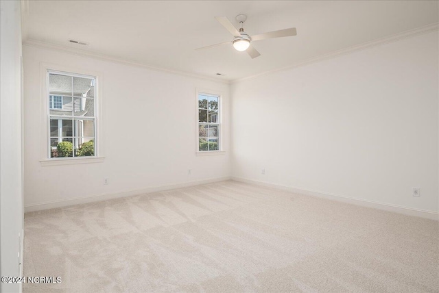 carpeted empty room featuring crown molding and ceiling fan