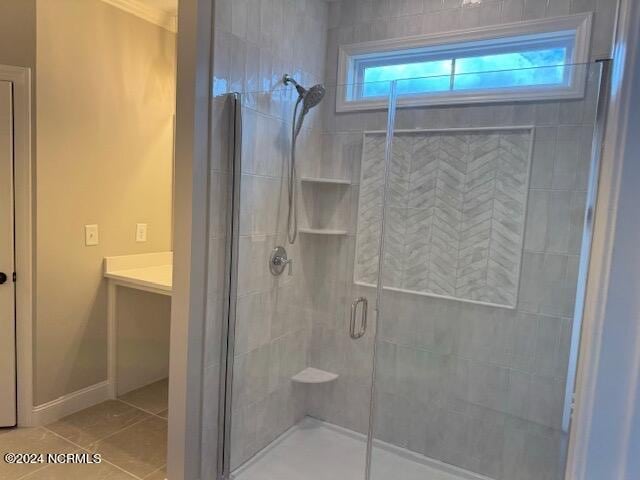 bathroom featuring a shower with door and tile patterned floors