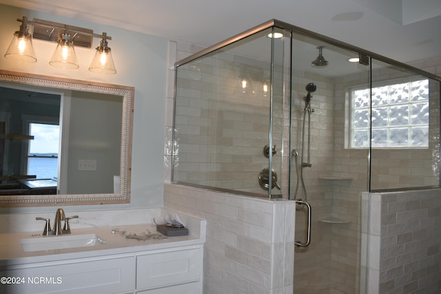 bathroom featuring vanity and an enclosed shower