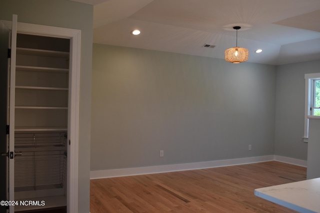 interior space with baseboards, wood finished floors, and recessed lighting