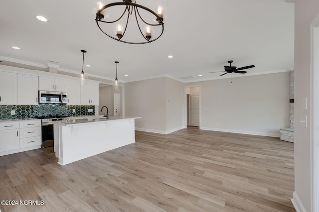 kitchen with pendant lighting, white cabinetry, an island with sink, and appliances with stainless steel finishes