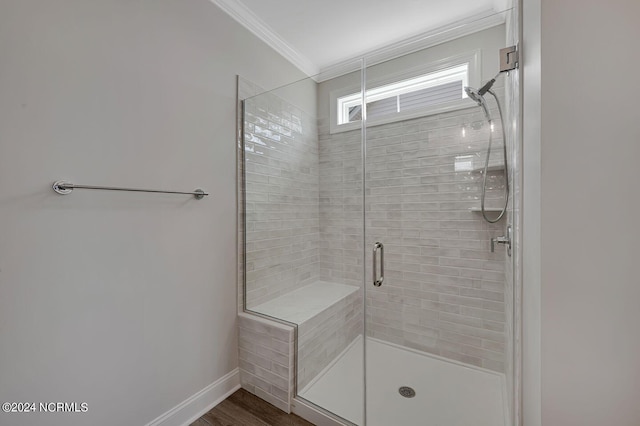 bathroom with crown molding, wood-type flooring, and a shower with shower door