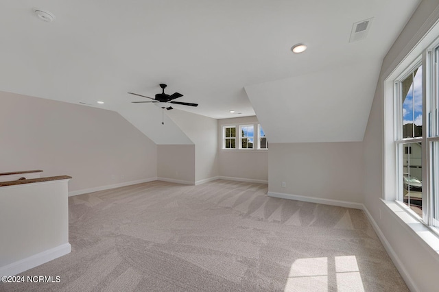 bonus room featuring light carpet, vaulted ceiling, and ceiling fan