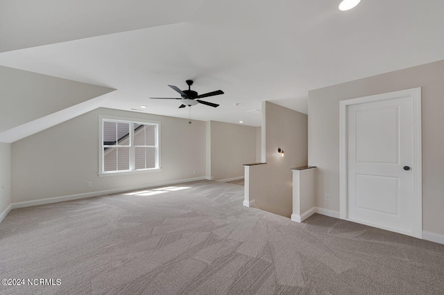 bonus room with ceiling fan, lofted ceiling, and light carpet