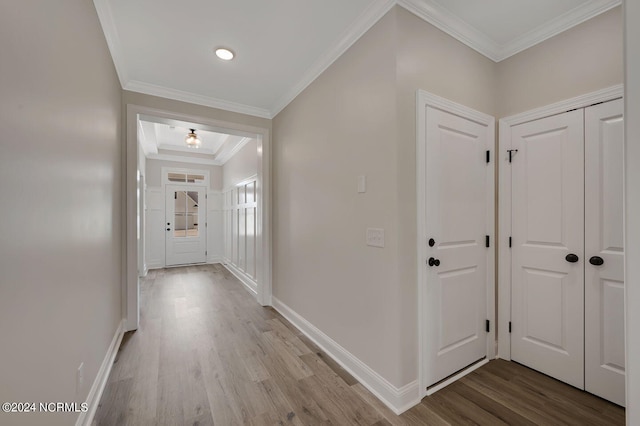 hallway featuring light hardwood / wood-style floors and crown molding