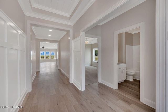 hallway featuring light hardwood / wood-style floors, plenty of natural light, and crown molding