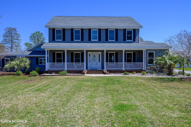 colonial inspired home featuring a front yard and covered porch