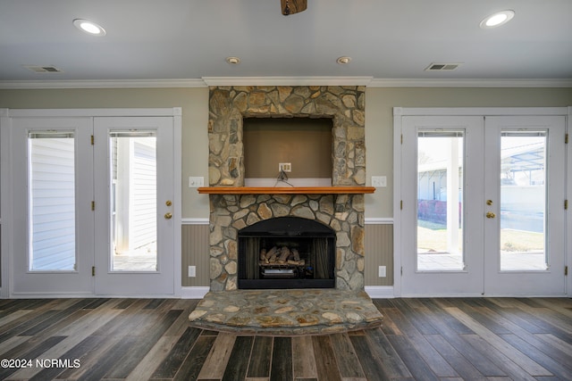 unfurnished living room with dark hardwood / wood-style flooring, crown molding, a fireplace, and french doors